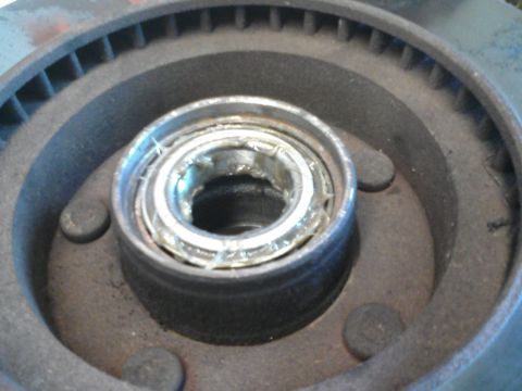 1986 Ford Bronco - Close-up view of a wheel bearing assembly, likely needing replacement.