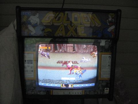 1978 Ford Bronco - Photograph of a Golden Axe arcade game cabinet showing the game in progress on its screen.