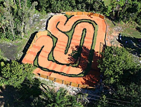 1986 Ford Bronco - An aerial view shows a winding RC car track designed for racing, set within a natural, wooded environment.