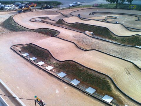 1986 Ford Bronco - A detailed view of an outdoor RC car track, various jumps, banked turns, and a tunnel section.