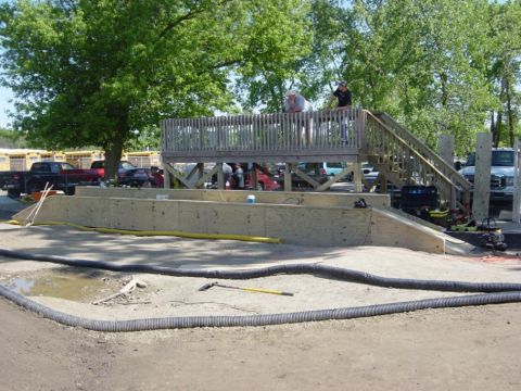 1986 Ford Bronco - RC car track setup with an elevated viewing platform and surrounding trees.