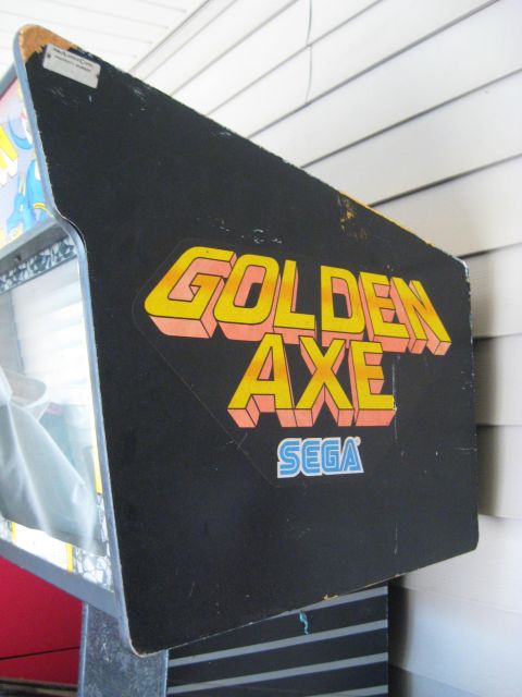 1978 Ford Bronco - Side panel of a Golden Axe arcade cabinet with the Sega logo visible.