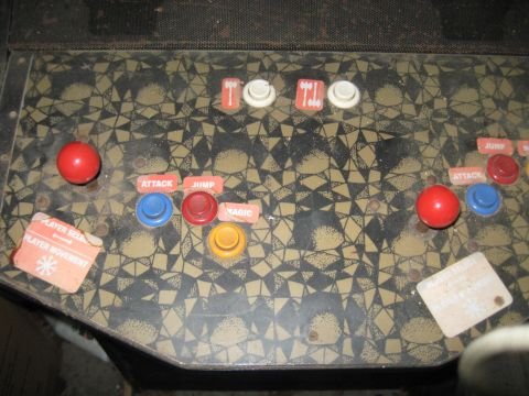 1978 Ford Bronco - This arcade game control panel features dual red joysticks and a variety of action buttons, including labels for attack, jump, and magic.