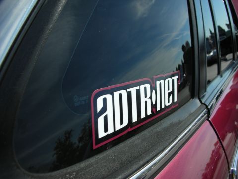 1992 Ford Crown Victoria - A sticker with the text ADTR.net is affixed to the tinted rear window of a vehicle.