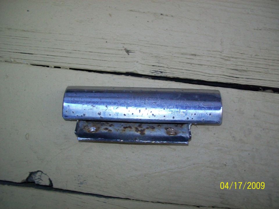 chrome trim piece with rusted mounting bracket