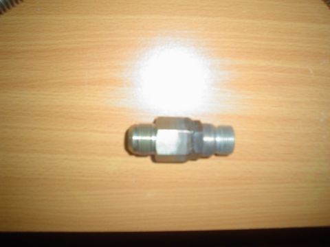 1996 Mercury Grand Marquis - A metal fitting is shown against a wooden background, with the Supermotors logo visible at the bottom right.