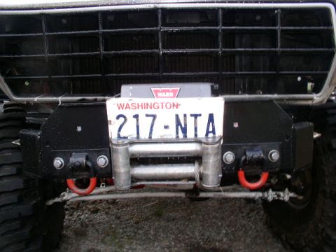1979 Ford Bronco - This vehicle features a winch mounted on the front bumper, along with red tow hooks and a Washington state license plate.