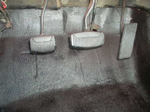 1979 Ford Bronco - Close-up of the floor pedals in a vehicle, showing the clutch, brake, and accelerator.