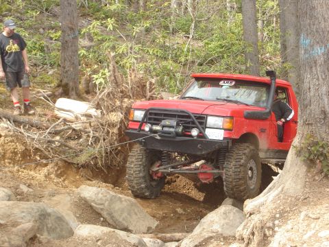 1989 Ford Bronco - This red 1989 Ford Bronco navigates a rocky trail with a winch and snorkel attached.