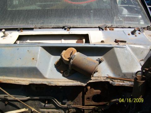 1972 Ford Ranchero - A close-up view of a windshield wiper motor assembly on a weathered vehicle cowl, dated 04/16/2009.