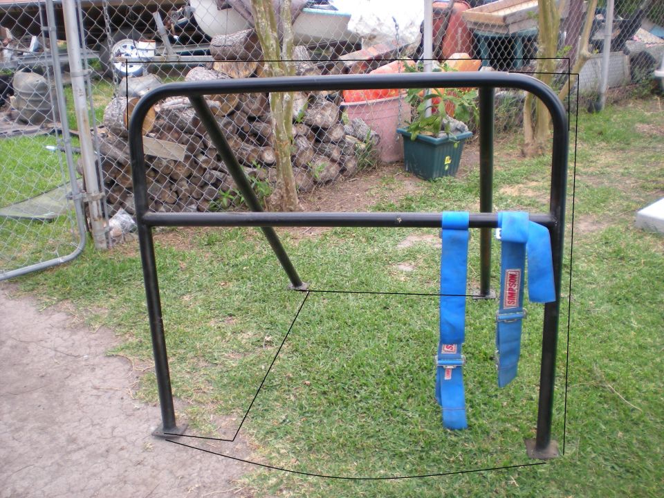 roll cage with blue Simpson seatbelts attached