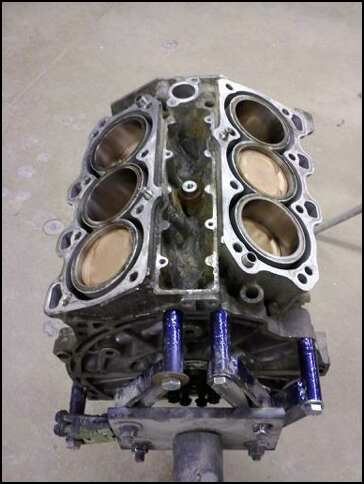 1994 Ford Probe - Engine block with cylinders visible, mounted on a stand, with Supermotors.net logo.
