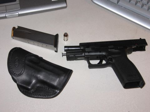 2001 Ford F-150 - A pistol, loaded magazine, and holster are laid out on a desk next to a keyboard and keyboard.