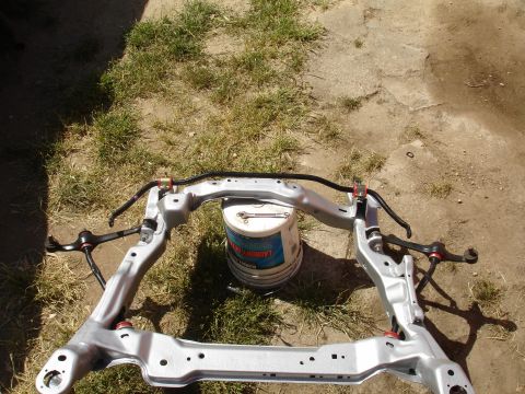 1995 Ford Taurus - Front subframe assembly with sway bar and control arms, likely for a vehicle restoration project.