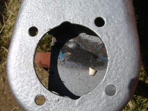 1995 Ford Taurus - Close-up view of a silver painted metal component, likely a suspension part, with a central opening and mounting holes.