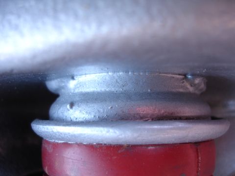 1995 Ford Taurus - Detail of a vehicle's suspension system, likely a shock absorber mount.