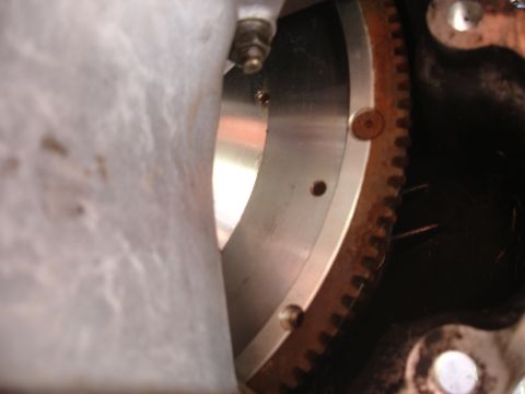1995 Ford Taurus - Close-up view of a rusty starter ring gear on a flywheel.