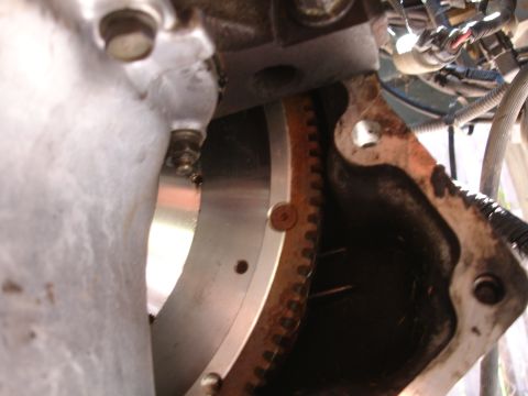 1995 Ford Taurus - A close-up view of a vehicle's engine flywheel and transmission housing, showing mechanical components.