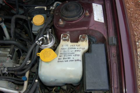 2001 Ford Crown Victoria - Handwritten notes detail recent maintenance, including new piston rings and a water pump, in the engine bay.
