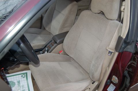 2001 Ford Crown Victoria - Interior view of a car showing the front seats and dashboard area around the steering wheel.