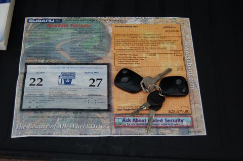 2001 Ford Crown Victoria - Subaru window sticker and keys displayed on a dark surface.