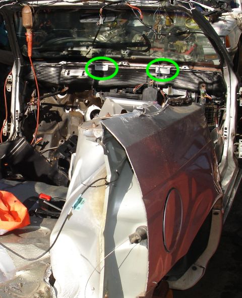 1993 Ford Taurus - The interior of a 1993 Ford Taurus shows significant damage to the dashboard and exposed wiring, with two green circles highlighting compon…