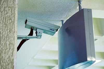 2005 Suzuki GSX-R 1000 - A security camera is mounted on a textured wall, positioned near a large, curved monitor.