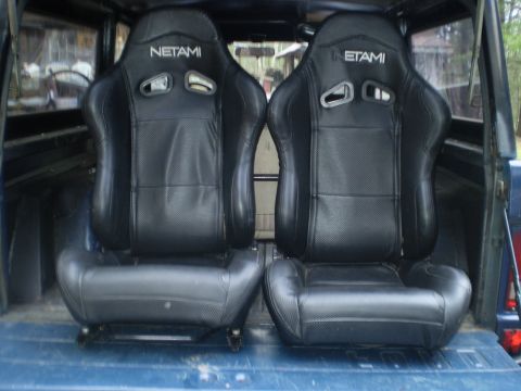 1979 Ford Bronco - Pair of Netami racing seats are shown in the cargo area of a vehicle.