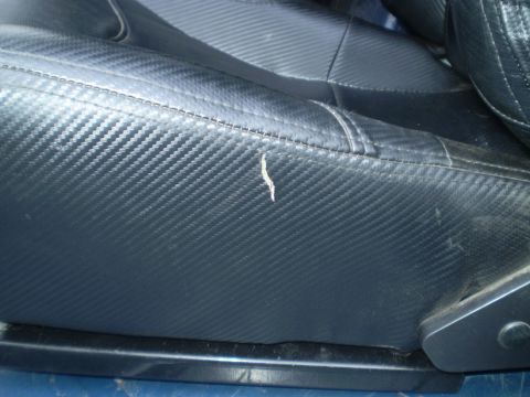 1979 Ford Bronco - The seat upholstery has a carbon fiber texture, but a small rip is visible on the side bolster.