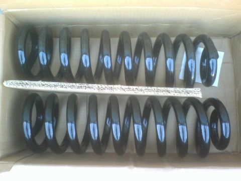 1984 Ford Bronco - Pair of suspension coil springs, likely aftermarket parts, shown in their packaging.