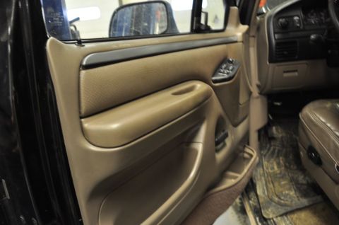 1996 Ford Bronco - Interior view of a tan door panel and brown leather seat, likely from a 1992 Ford F-Series truck.