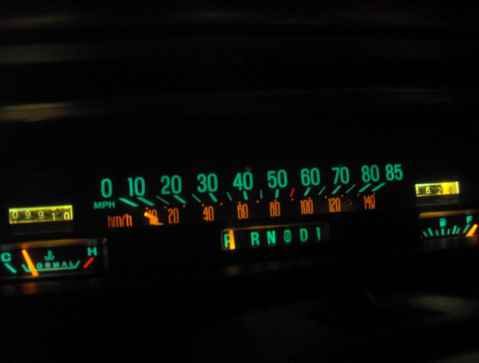 Dashboard gauges showing speed, odometer, fuel, and gear selection