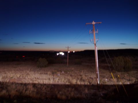 2009 Kenworth T800 - Dusk scene with a utility pole and distant lights on the horizon.