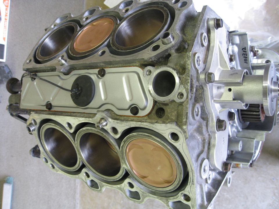 Engine block with pistons visible, close-up view