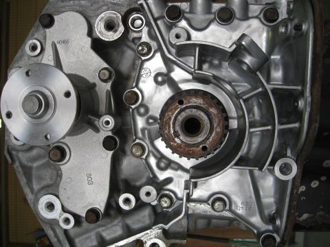1994 Ford Probe - Engine block detail showing a water pump pulley and a toothed timing gear.