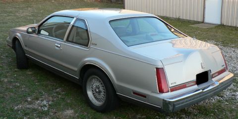 1990 Lincoln Mark VII - Rear view of a 1990 Lincoln Mark VII coupe parked outdoors on grass.