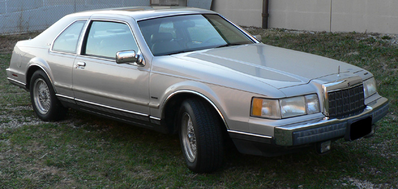 1990 Lincoln Mark VII coupe parked on grass, front 3/4 view