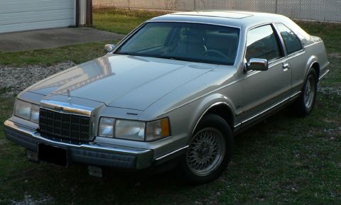 1990 Lincoln Mark VII - A silver 1990 Lincoln Mark VII coupe is shown from the front quarter angle.
