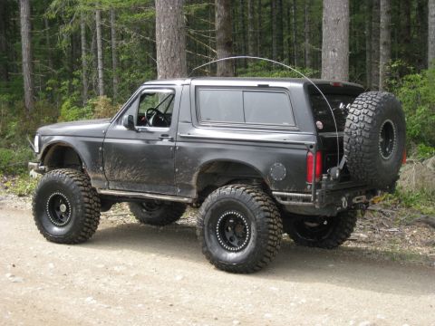 1979 Ford Bronco - This modified SUV, likely a 1992-1996 Ford Bronco, is equipped for off-road use.