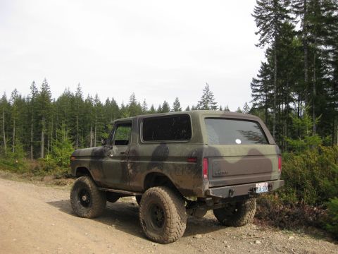 1979 Ford Bronco - This 1979 Ford Bronco, seen in a wooded area, features a camouflage paint scheme and lifted suspension.