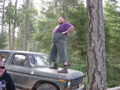 1979 Ford Bronco - A man poses on the hood of a 1979 Ford Bronco during an outdoor gathering.