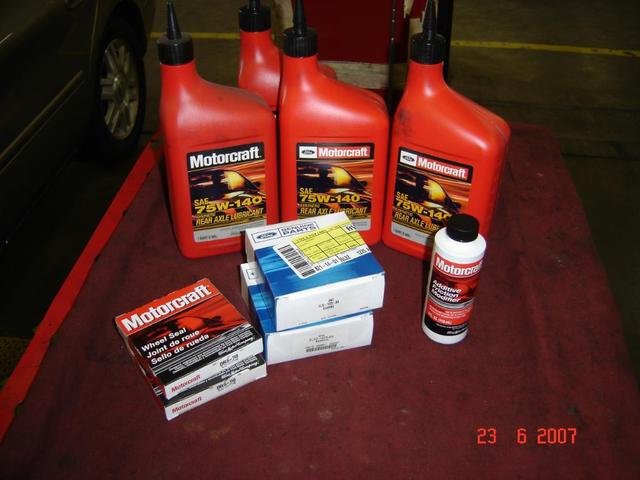 Motorcraft SAE 75W-140 rear axle lubricant bottles, wheel seal boxes, and additive bottles on a red cloth. Date stamp reads 23 6 2007