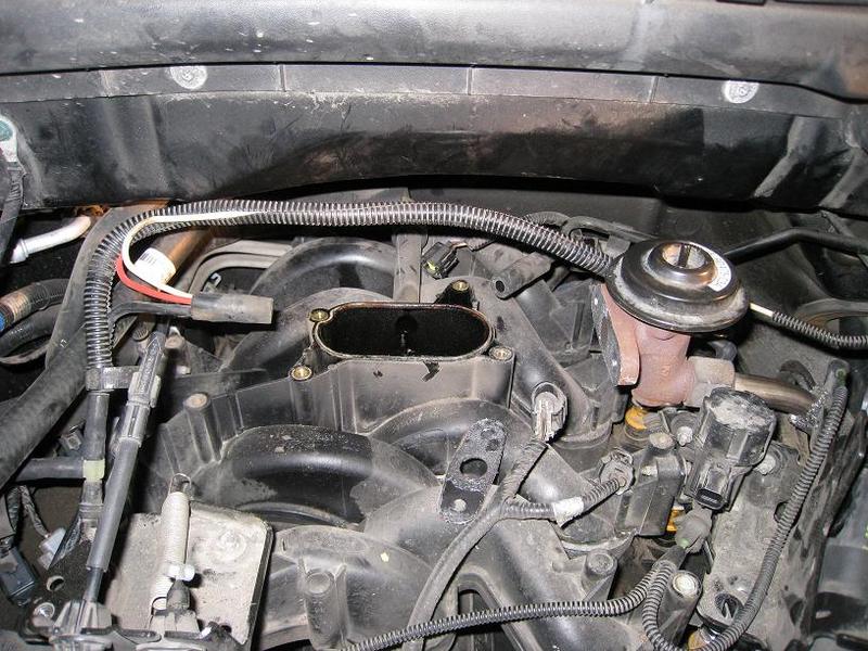 Engine intake manifold with black plastic components and metal exhaust gas recirculation valve