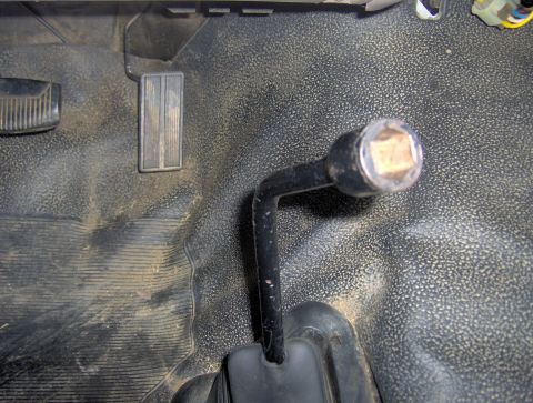 1995 Ford Bronco - The interior floor of a vehicle shows a gear shifter and pedals, with a watermark indicating the source.