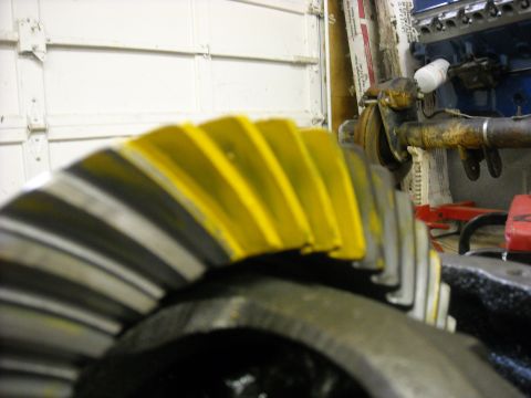 1979 Ford F-150 - A differential gear, likely from a truck or heavy equipment, is shown with its teeth highlighted in yellow paint.