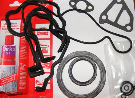 1994 Ford Probe - Engine gasket set and sealant tube are laid out on a white surface.