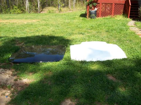 2007 Ford Mustang - Two car hoods, one black glass sunroof and one white, are laid out on a grassy lawn.