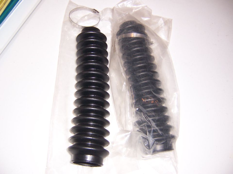two black rubber bellows with metal hose clamps, one in plastic packaging
