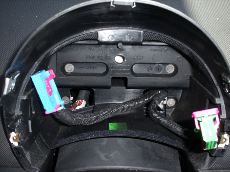 Back of VW Beetle instrument cluster panel with blue and green wiring connectors unplugged