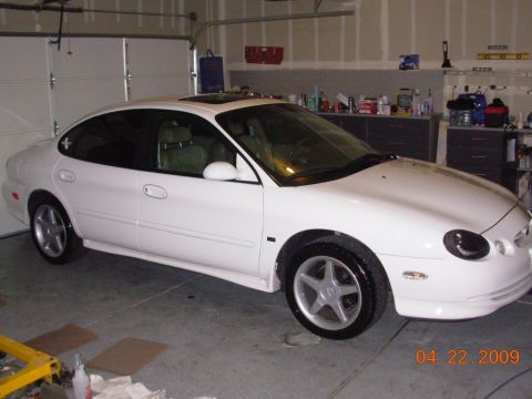 1995 Ford Taurus - A white sedan is parked in a garage with the garage door partially open. The date 04.22.2009 is visible in the lower right corner.
